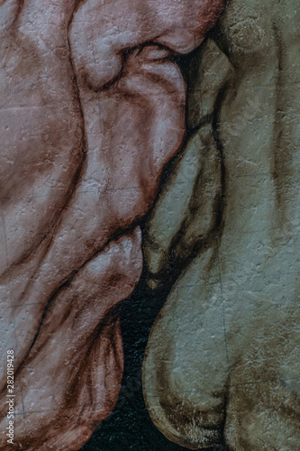  Very close detail of the lips kissing on the 'The Kiss of Death' painting, a symbol of the history of Berlin drawn onto the Berlin Wall at the East Side Gallery photo