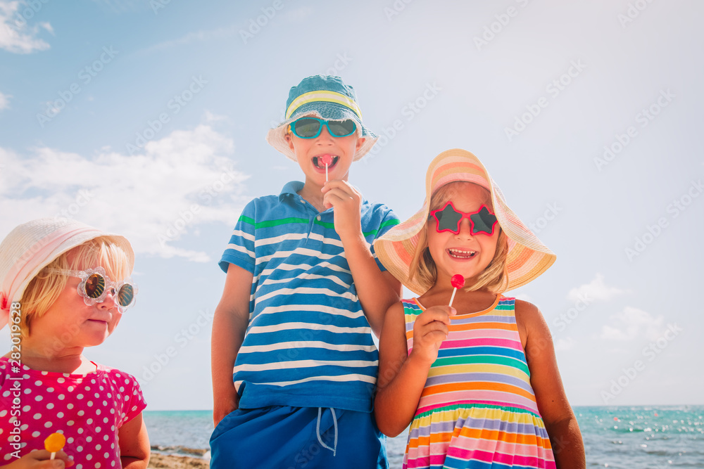 happy kids with lollipops on summer vacation