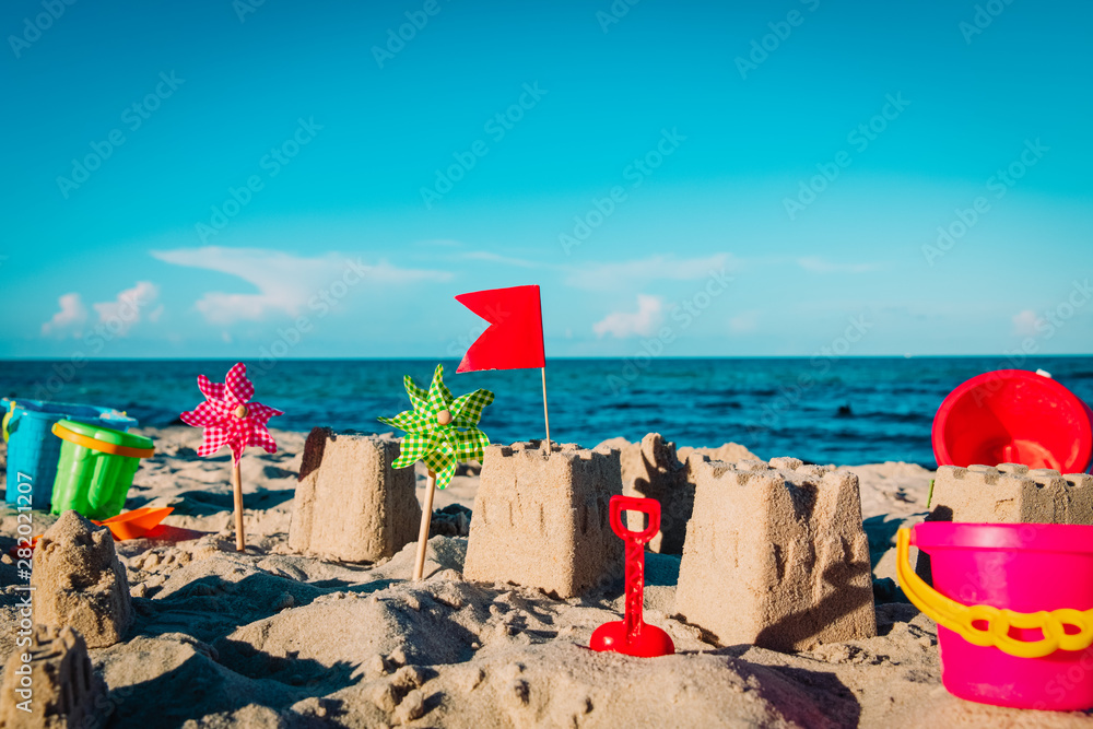 sand toys and castle on tropical beach, kids play on sea vacation