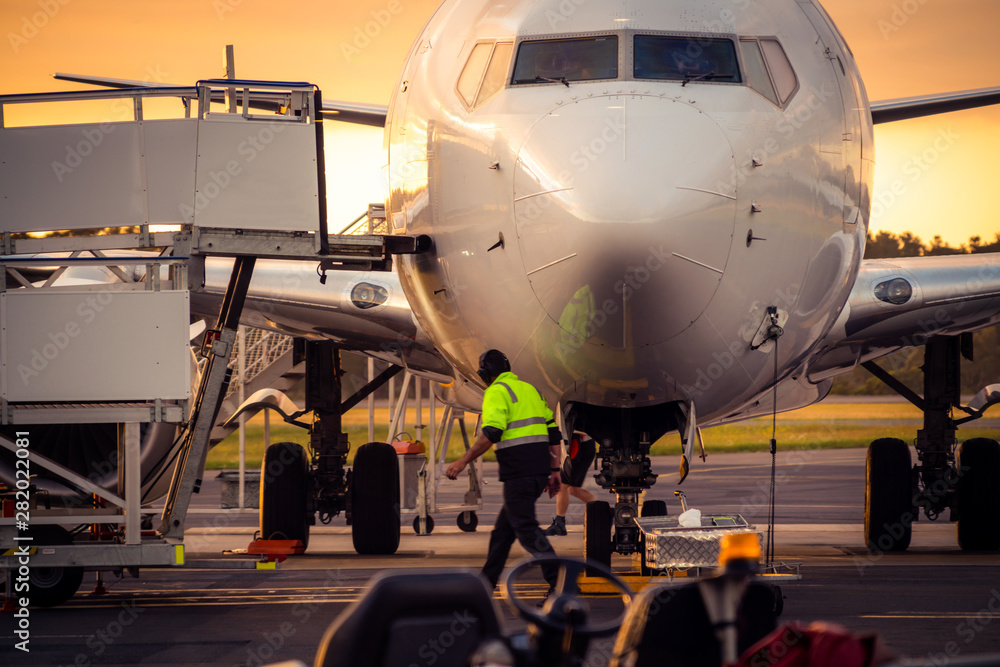 Φωτογραφία Sunset view of airplane on airport runway under dramatic sky in Hobart,Tasmania, Australia