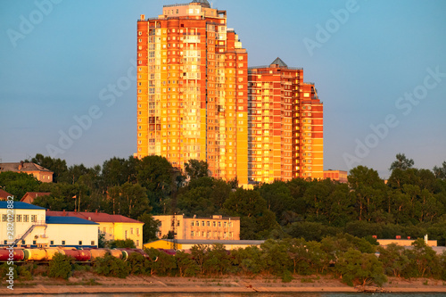 View of the city of Khabarovsk from the Amur river. Urban landscape in the evening at sunset.