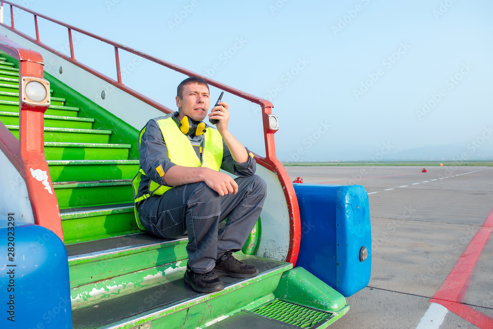 airport worker radio coordinate control ladder terminal