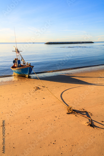 Fishing boats protected by breakwater photo