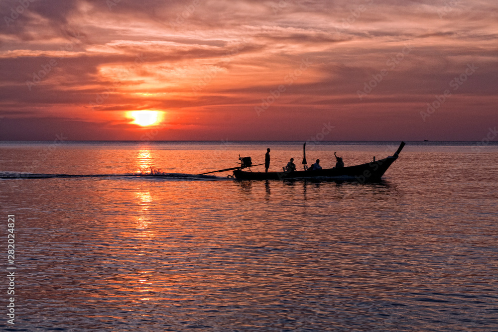 Long tailed boat at sunset, Nai Yang beach, Phuket, Thailand