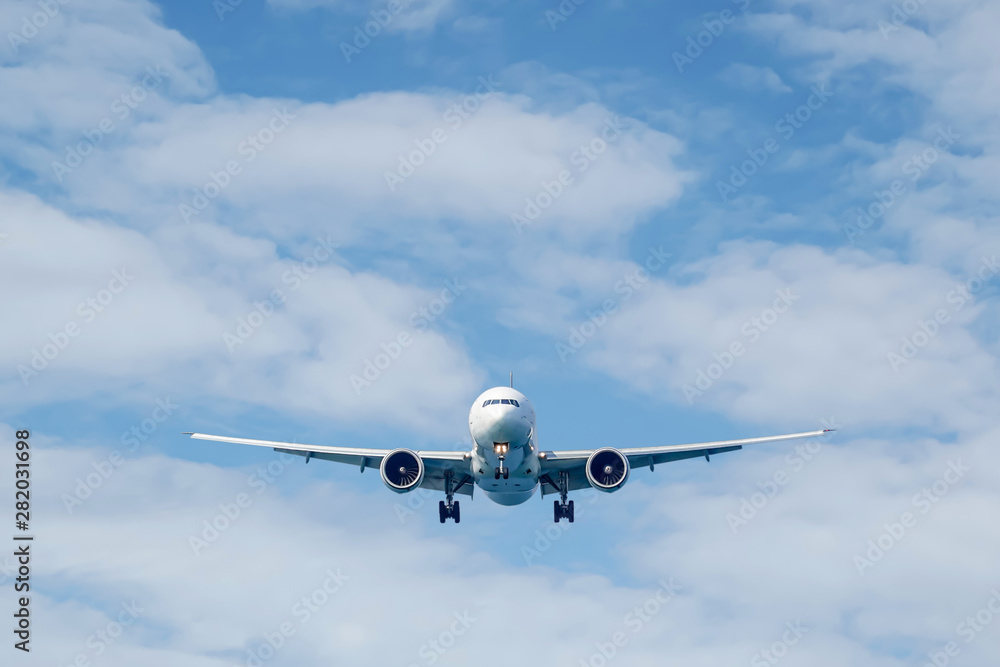 Passenger plane in flight. Aircraft fly high in the sky above the clouds. Front view of airplane. Passenger plane in flight. Aircraft fly high in the sky above the clouds. Front view of airplane.