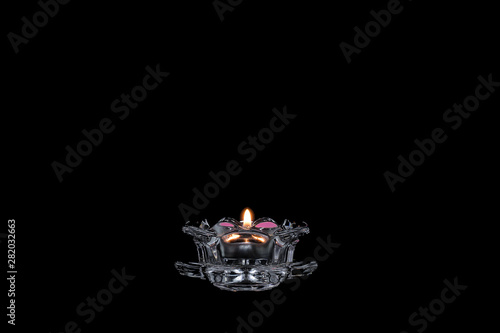 candle light on a black background, candlestick close-up, burning flame