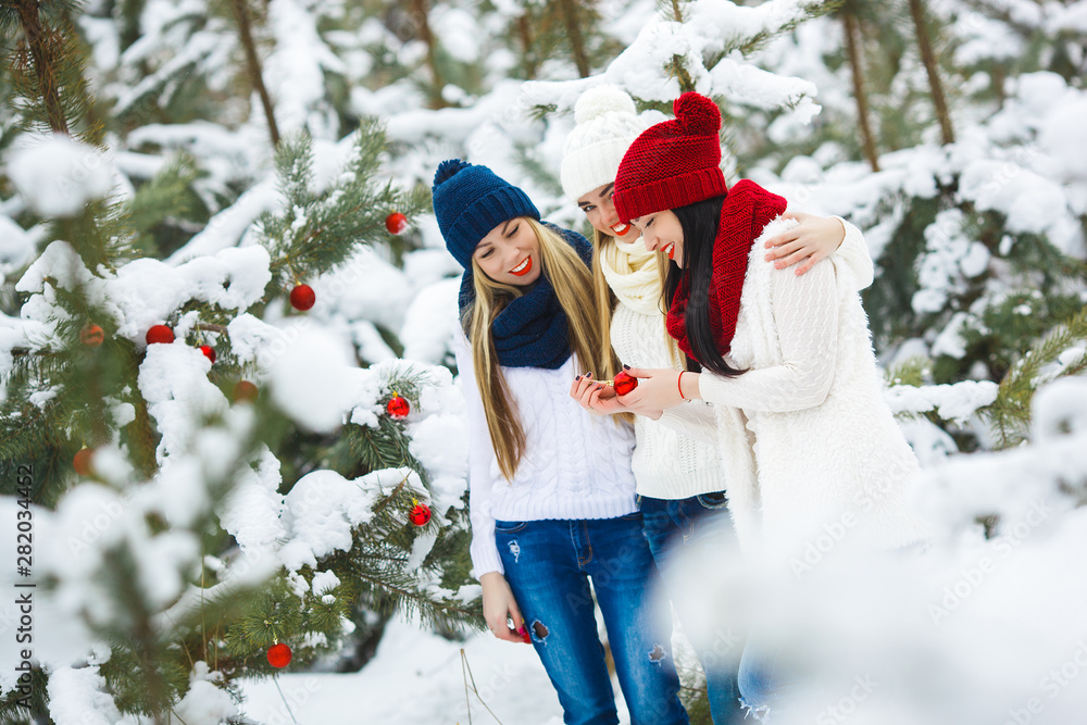 Women on Christmas background. Young girls hawing fun in winter time Women on Christmas background. Young girls hawing fun in winter time