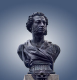 Bronze bust of Alexander Pushkin, isolated on gray background. Monument of great russian poet in Odessa, Ukraine.