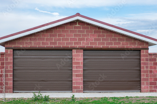 Brick garage with roller shutters for two cars