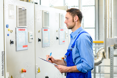 worker in front of control cabinet