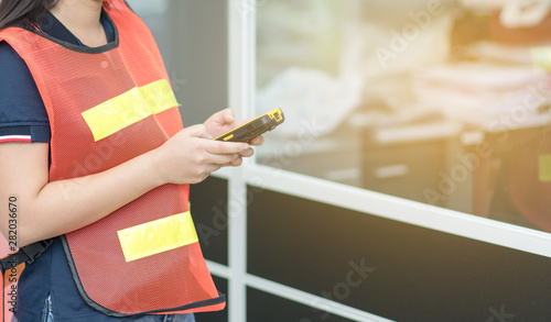 worker using smartphone in warehouse , scanner barcode