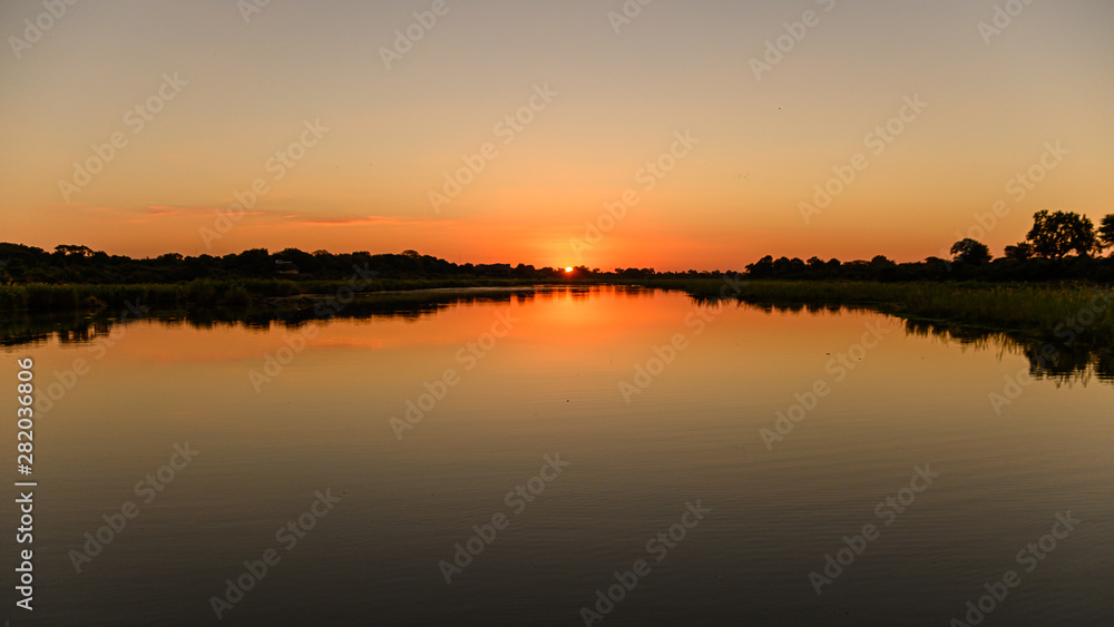 Colourful African sunset reflecting off the waters of the Sabie river in the Kruger National park 