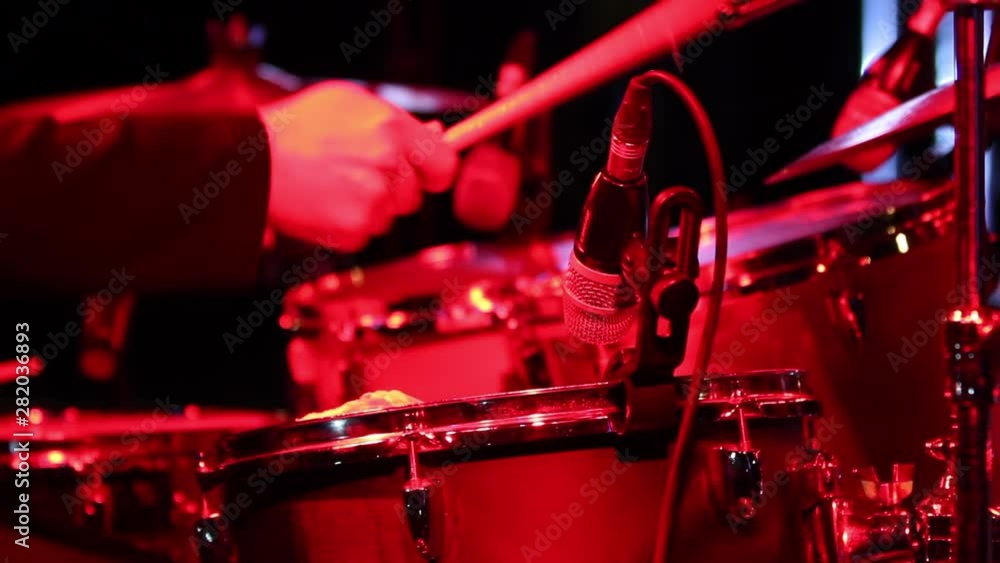Beating Drums is a stunning stock video that shows footage of a drummer playing drums on stage