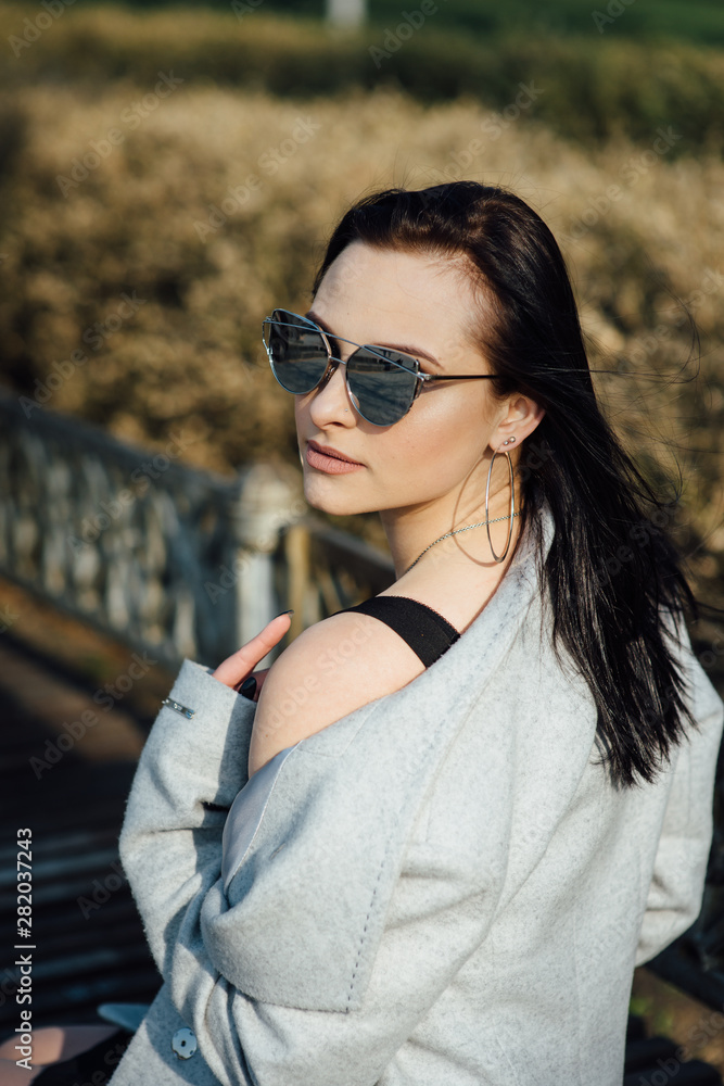 beautiful girl with brunette hair, posing outside, hipster style beautiful girl with brunette hair, posing outside, hipster style