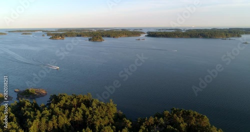 Boats in the Finnish archipelago, Aerial, tracking, drone shot panning around motorboats, on the Baltic sea, on a summer evening, in Tammisaaren saaristo national park, in Raasepori, Uusimaa, Finland photo