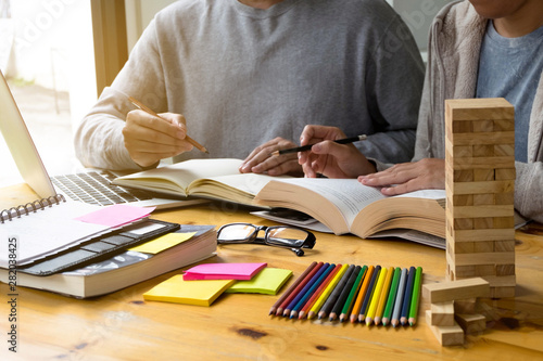 Students helps friend teaching and learning subject additional in library. Education concept.