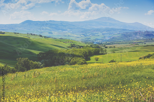 Beautiful landscape, spring nature. Mountain landscape. Top view of sunny fields on the hills in Tuscany, Italy