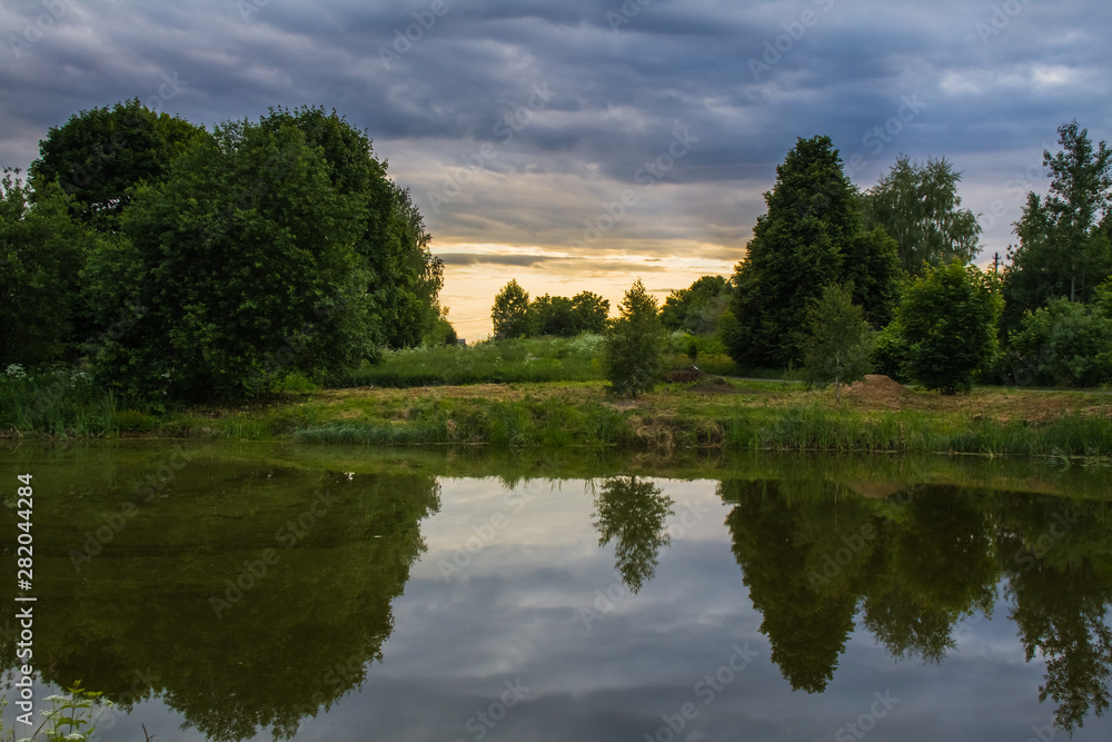 Summer pond at summer sunset