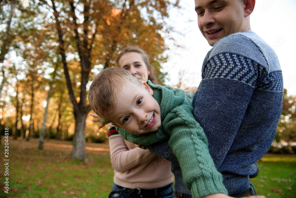 Happy family resting in beautiful autumn park Happy family resting in beautiful autumn park