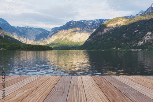 Alpine mountain range with lake in summer with wooden patio © SasinParaksa