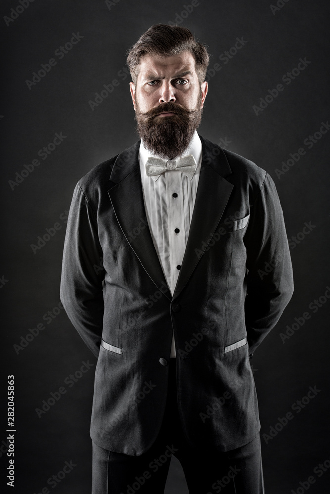 Well dressed and scrupulously neat. Hipster formal suit tuxedo. Official event dress code. Male fashion. Classic style. Classic never out of trend. Menswear classic outfit. Bearded man with bow tie Well dressed and scrupulously neat. Hipster formal suit tuxedo. Official event dress code. Male fashion. Classic style. Classic never out of trend. Menswear classic outfit. Bearded man with bow tie