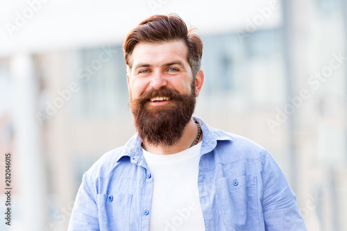 Create personal style with facial hair. Hipster with stylish beard and mustache urban background. Bearded man unshaven face hair. Barbershop and hairdresser. Masculine beauty. Styling hair tips