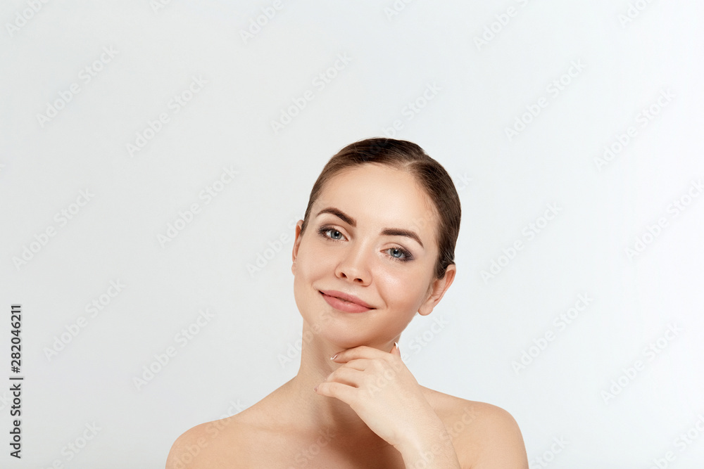Beautiful Young Woman with Clean Fresh Skin touch own face. Facial treatment. Cosmetology, beauty and spa. Skin care. Model With Natural Makeup Beautiful Young Woman with Clean Fresh Skin touch own face. Facial treatment. Cosmetology, beauty and spa. Skin care. Model With Natural Makeup