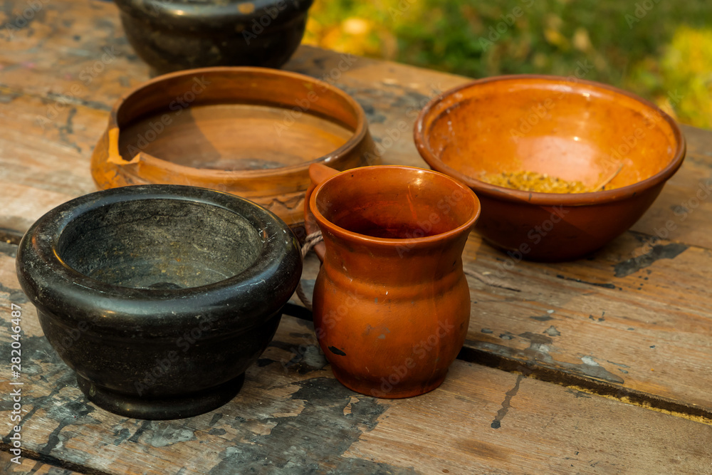 set brown pottery deep plate jug mug mortar set rustic kitchen on wooden table set brown pottery deep plate jug mug mortar set rustic kitchen on wooden table