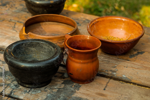 set brown pottery deep plate jug mug mortar set rustic kitchen on wooden table © Kai Beercrafter
