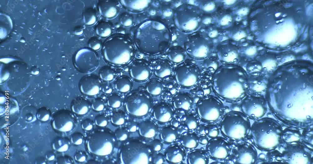 Color drops floating in oil and water over a colorful background Color drops floating in oil and water over a colorful background