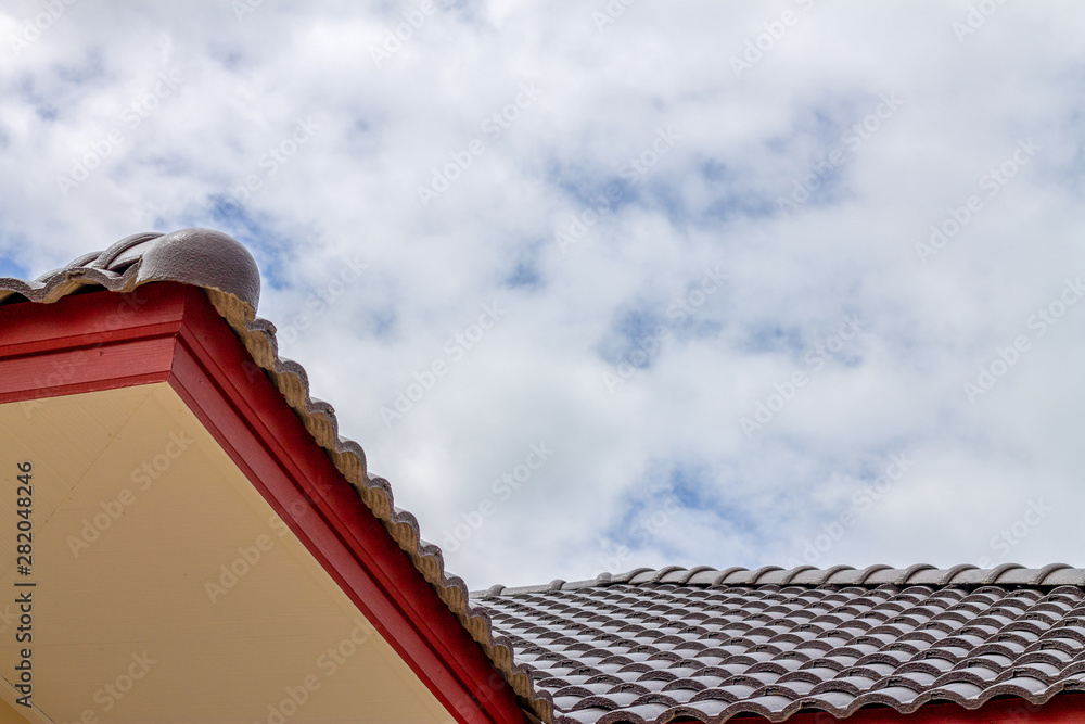 The gable roof with the sky with clouds background. The gable roof with the sky with clouds background.