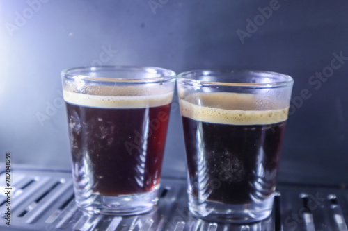 Close-up of espresso pouring from coffee machine. Professional coffee brewing