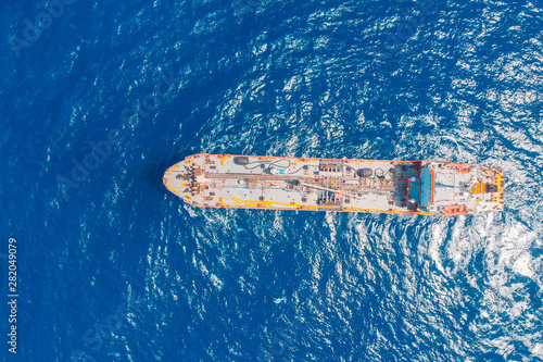 Oil ship chemical tanker sails blue sea. Aerial top view. Concept export