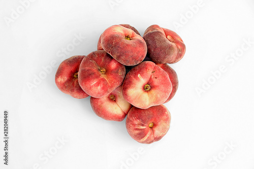 group of ripe flat peaches, isolated on a white background photo