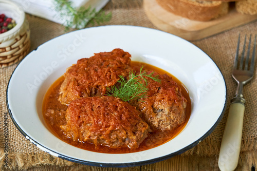 Meat cutlets with cabbage in tomato sauce