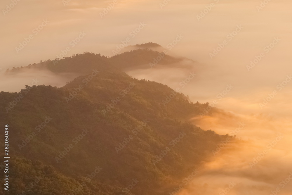 Mountain view misty morning of top hills around with sea of mist in valley background, sunrise at Pha Tang, Chiang Rai, northern of Thailand. Mountain view misty morning of top hills around with sea of mist in valley background, sunrise at Pha Tang, Chiang Rai, northern of Thailand.