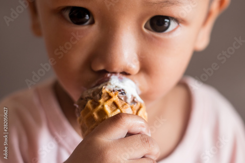 young boy eat ice cream face close-up