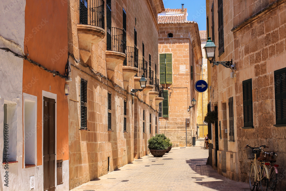 Empty street of Ciutadella town in hot summer noon, Menorca, Spain