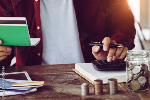 Photography asian man working with calculator to calculate numbers