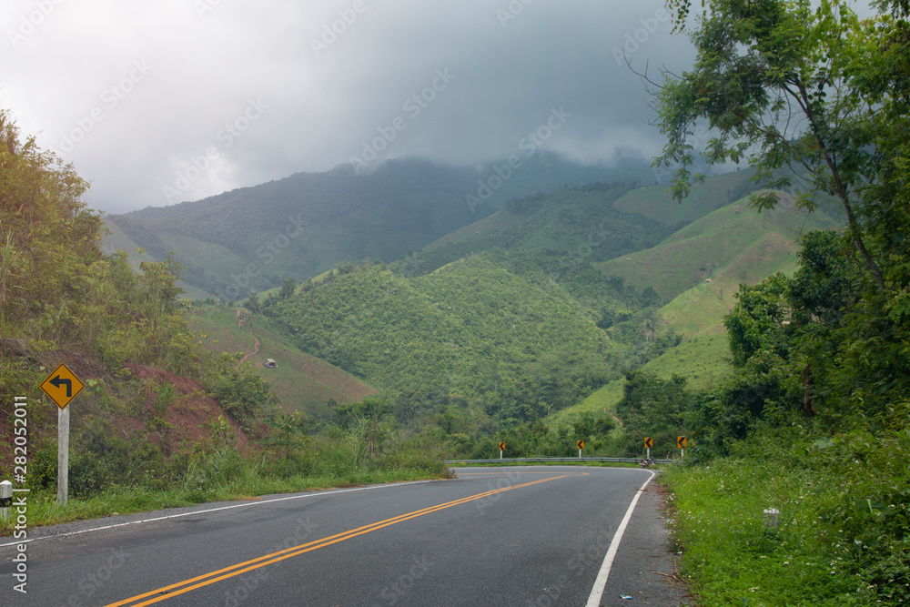 Asphalt road through with sign curves in the mountains. Asphalt road through with sign curves in the mountains.