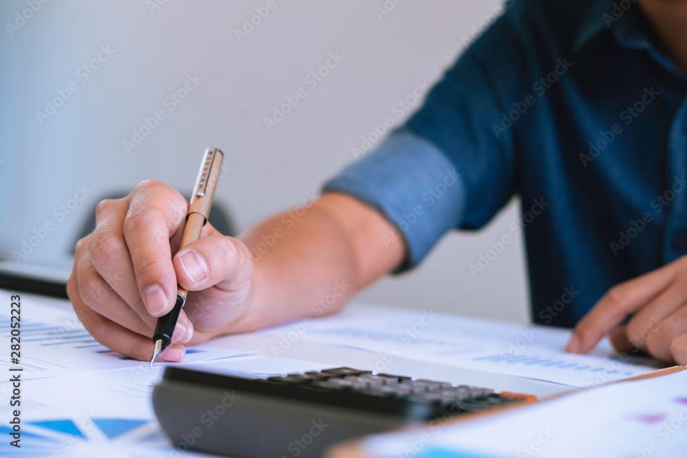 Office workplace with business finance, accounting,laptop on wood table.finance statistics and analytic research concept Office workplace with business finance, accounting,laptop on wood table.finance statistics and analytic research concept