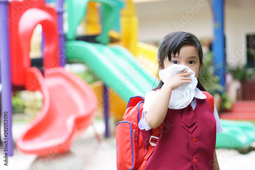 Photography Asian child student or kid girl sick with sneezing on nose and cold cough on han