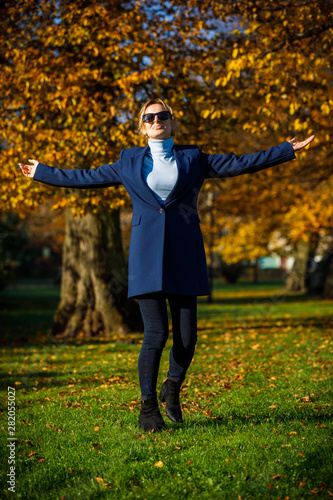 Middle-aged woman walking in city park © Jacek Chabraszewski