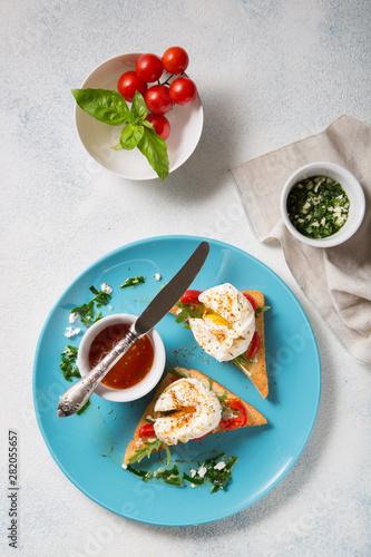 A traditional dish of French cuisine. Poached eggs with spices on a light background Top view