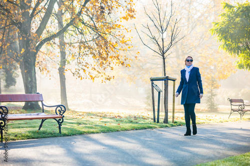 Middle-aged woman walking in city park