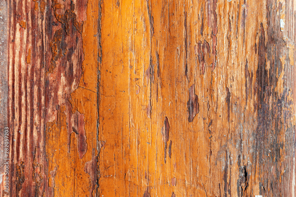 Peeling orange paint of old brown wood desk. scratched wooden flooring with lacquer peeled off– background for design. Peeling orange paint of old brown wood desk. scratched wooden flooring with lacquer peeled off– background for design.