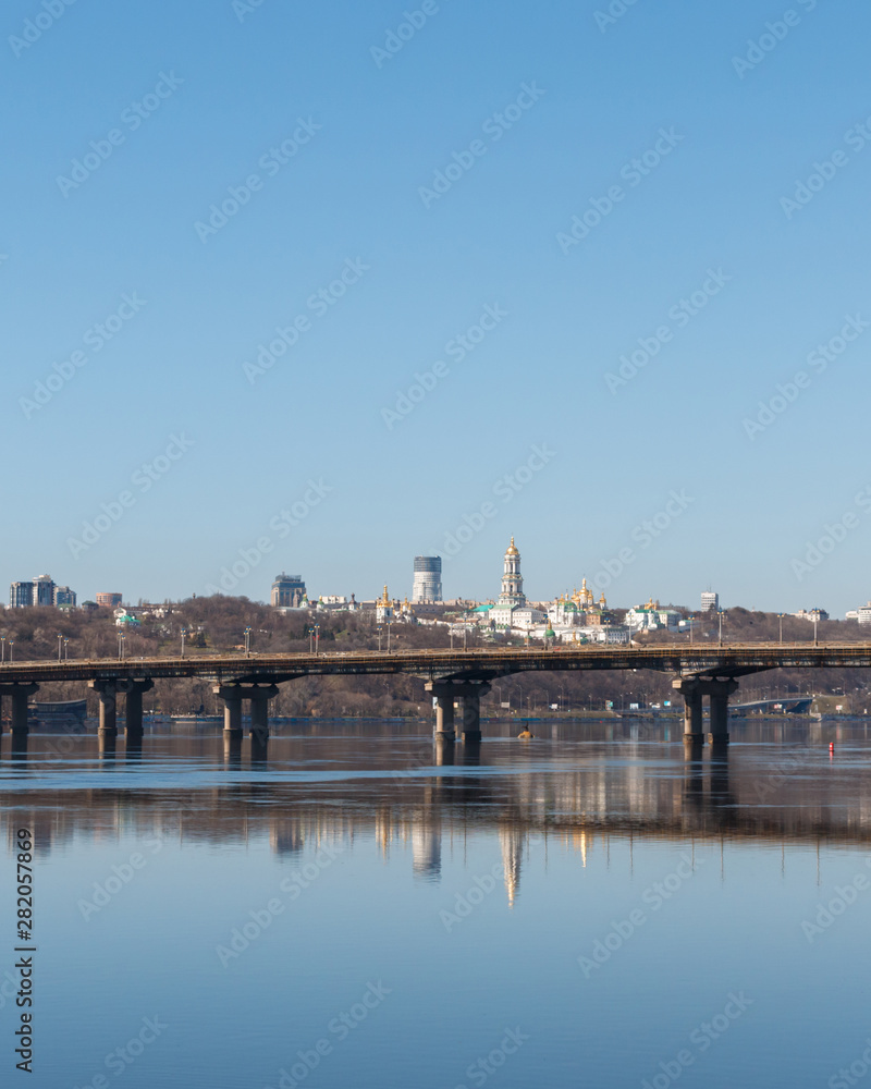 view of the right bank of Kyiv, the Dnieper River and the Paton Bridge. Paton Bridge is one of the bridges across the Dnieper in Kiev, early spring day. Panoramic View to the right bank of Kyiv.