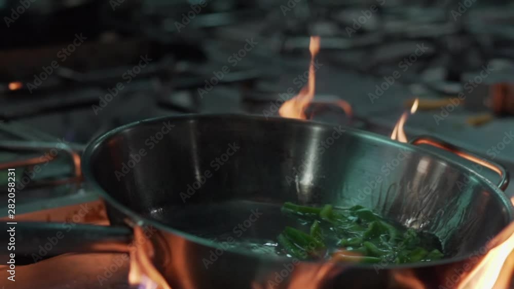 Cooking with a pan with fire Cooking with a pan with fire