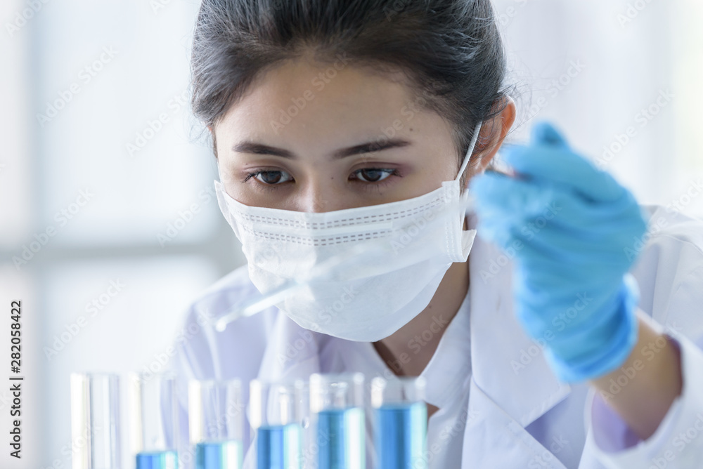 Asian young girl student scientist researching and learning in a laboratory. Asian young girl student scientist researching and learning in a laboratory.