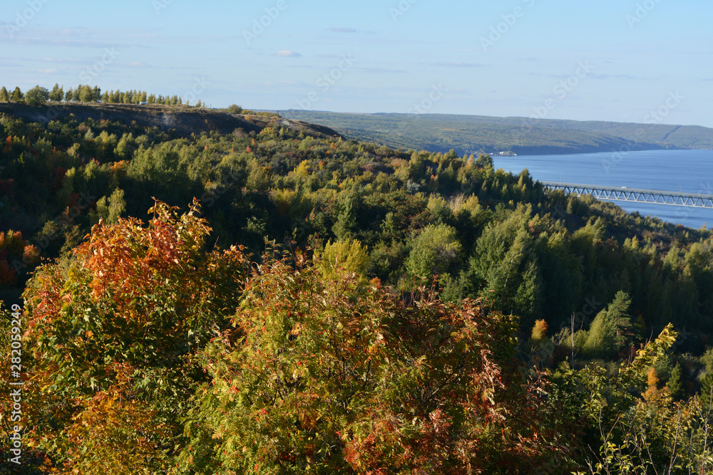 Beautiful landscape with forest on the bank of Volga river. Picturesque scene in fall.